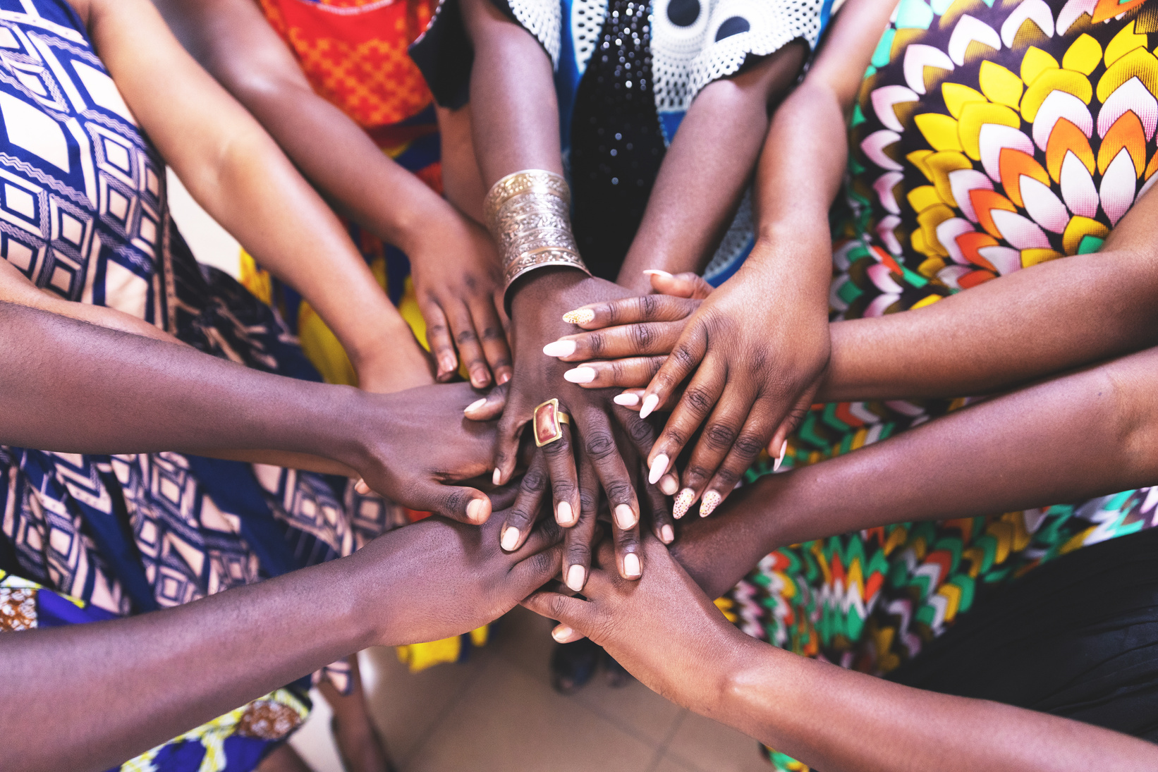 Group of African Women Joining Hands in Unity
